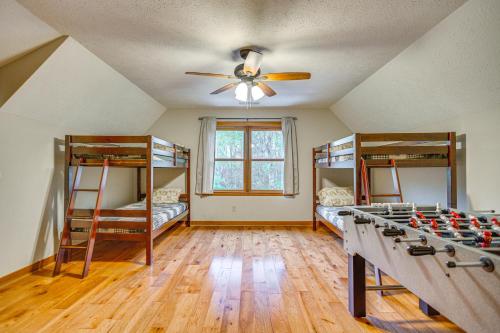 a room with two bunk beds and a ceiling fan at Large Dahlonega Home, Ideal for Family Gatherings! in Dahlonega