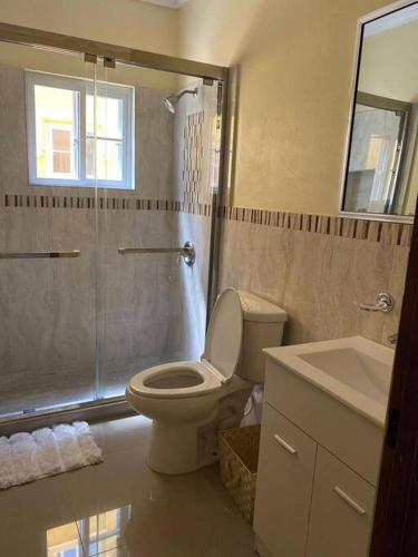 a bathroom with a toilet and a shower and a sink at Serenity Escape Apt 5 in Runaway Bay