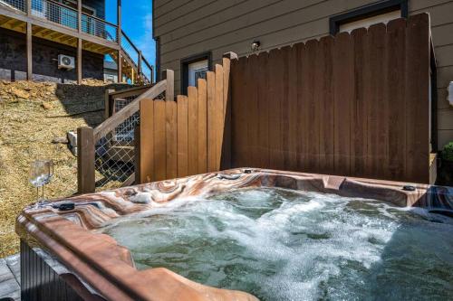 a hot tub in the backyard of a house at Tranquility/Mountain Cabin/Indoor Pool/Hot Tub/Games/Views in Sevierville