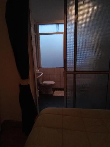 a room with a bathroom with a toilet and a window at San Sebastián in Concepción