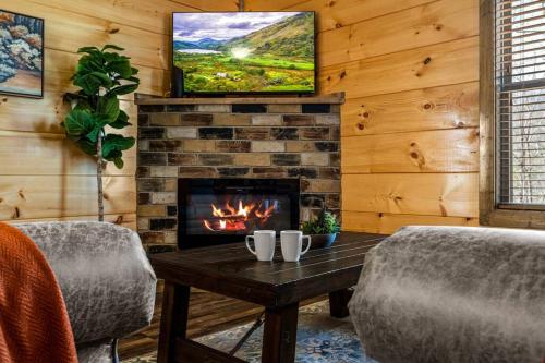 a living room with a fireplace and a tv at Tranquility/Mountain Cabin/Indoor Pool/Hot Tub/Games/Views in Sevierville