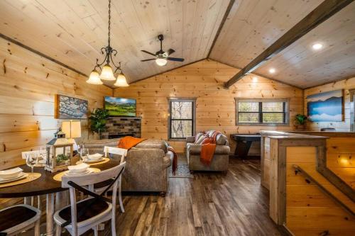 a log cabin living room with a table and chairs at Tranquility/Mountain Cabin/Indoor Pool/Hot Tub/Games/Views in Sevierville