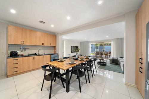 a kitchen and dining room with a table and chairs at Coopers Cottage - Spacious Pool Escape with Studio in Woodville