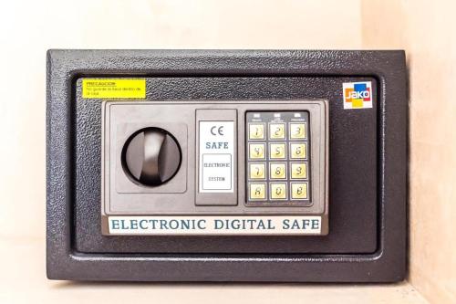 an electronic digital safe sitting on a wall at UJO Condo Boutique in Tulum