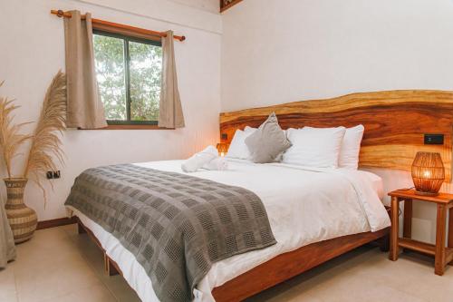 a bedroom with a large bed and a window at Masaya Casas Viejas in Minca