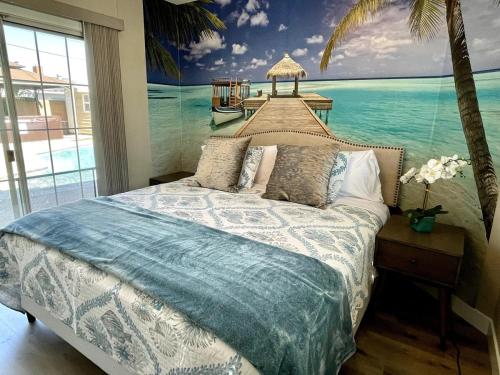 a bedroom with a bed with a painting of the ocean at Orchard Villa Disneyland 5 Bedroom Pool Home Spa in Anaheim