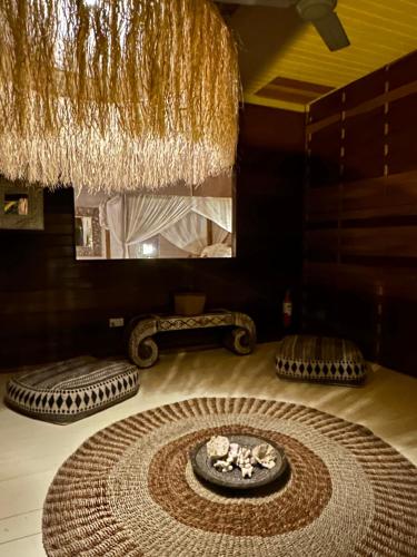 a room with a large rug on the floor with a mirror at Samura Maldives Guest House Thulusdhoo in Thulusdhoo