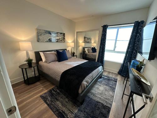 a bedroom with a bed and a large window at The Century City Cozy 3 Bedroom Apartment with free parking! in Los Angeles