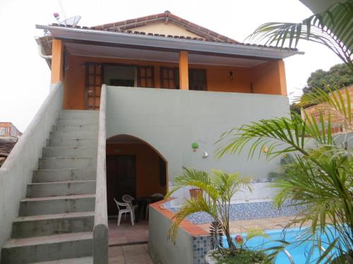 a house with stairs leading to a swimming pool at Hostel Casa Gaia - Centro de Arraial d'Ajuda in Porto Seguro