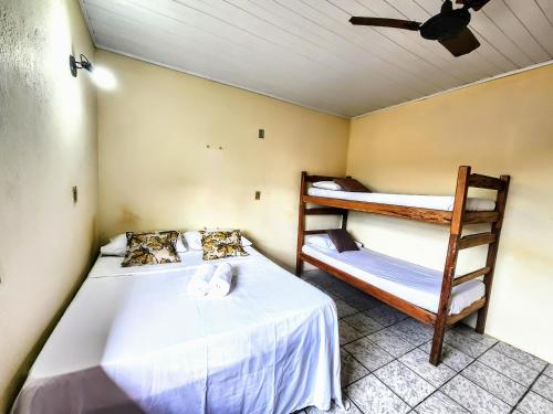 a bedroom with two bunk beds and a ceiling at Hostel Casa Gaia - Centro de Arraial d'Ajuda in Porto Seguro