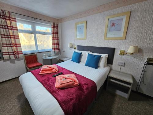 a hotel room with a bed with towels on it at Collingwood Hotel in Blackpool