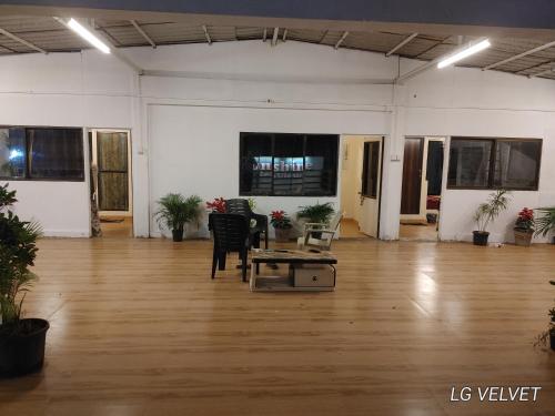 a large room with a table in the middle of it at Sunshine Resort in Surai