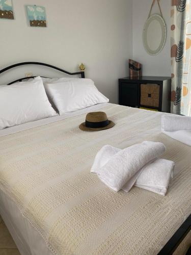 a bed with two pillows and a hat on it at Gianna's house in Nikiti