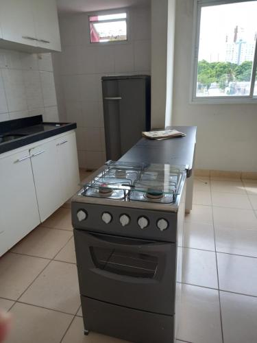 a kitchen with a stove top oven in a room at Aluguel por temporada em Cuiabá in Cuiabá