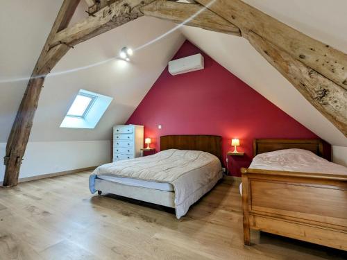 two beds in a attic bedroom with red walls at Maison de charme en Berry - proche Zoo de Beauval et Cité médiévale de Loches - FR-1-591-169 in Arpheuilles