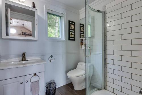 a bathroom with a toilet and a sink and a shower at Un havre de paix! in Saint Adolphe D'Howard