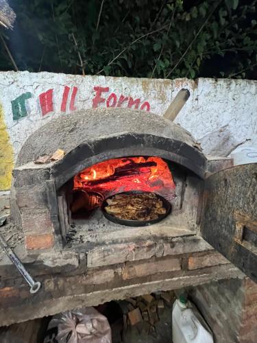 a pizza is cooking in an outdoor oven at Casa in Tristán Suárez