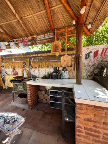 an outdoor kitchen with a counter and a table at Casa in Tristán Suárez