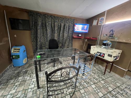a room with a glass table and a chair at Casa in Tristán Suárez