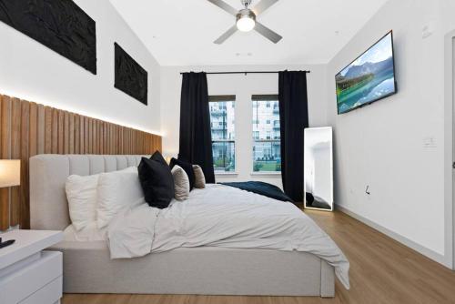 a bedroom with a large bed and a window at Modern Luxury Sanctuary Apt in DownTown Boston in Chelsea