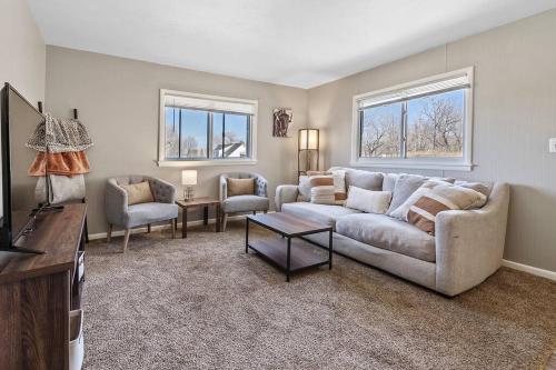 a living room with a couch and a tv at Downtown Condo-Lower Level in Rapid City