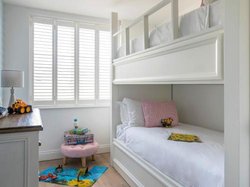 a childs bedroom with a bunk bed and a chair at The Hedgehog-Uk46923 in Newby Bridge