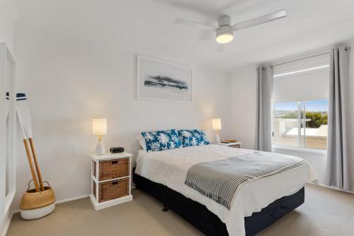 een witte slaapkamer met een bed en een raam bij The Shack Port Elliot - Wi-Fi - Family - BYO Linen in Port Elliot