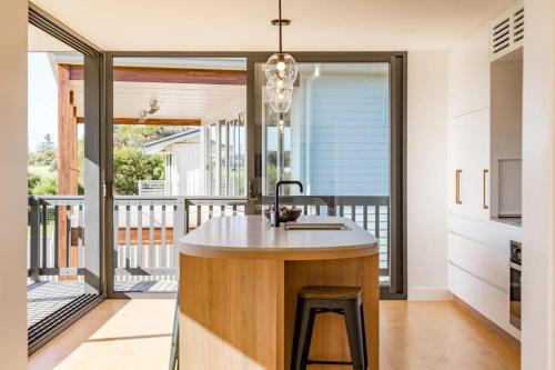a kitchen with a island with a sink at 81 Bristow-Smith Ave Goolwa Beach - BYO Linen - WiFi in Goolwa South