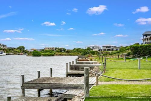 a dock with several boats in a body of water at Hindmarsh Island Marina Lifestyle - BYO Linen in Hindmarsh Island