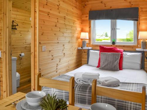 a room with a bed in a log cabin at Halifax - Uk47056 in Holme upon Spalding Moor