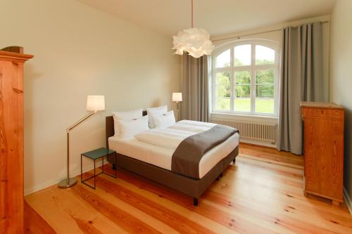 a bedroom with a bed and a large window at Ferienwohnungen Bahnhof Werder in Jüterbog