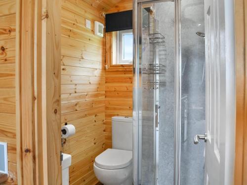 a bathroom with a toilet and a glass shower at Halifax - Uk47056 in Holme upon Spalding Moor