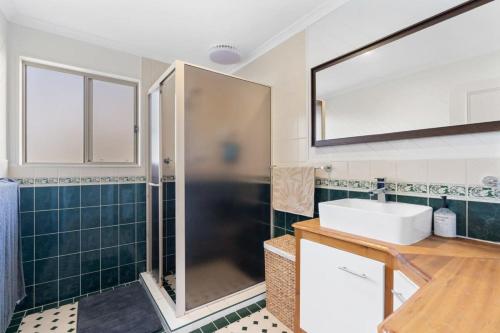 a bathroom with a sink and a shower at Shanti - 4 Channon St Port Elliot BYO Linen in Port Elliot