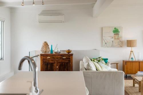 a living room with a couch and a table at 10 Passatt St Encounter Bay - BYO Linen in Encounter Bay