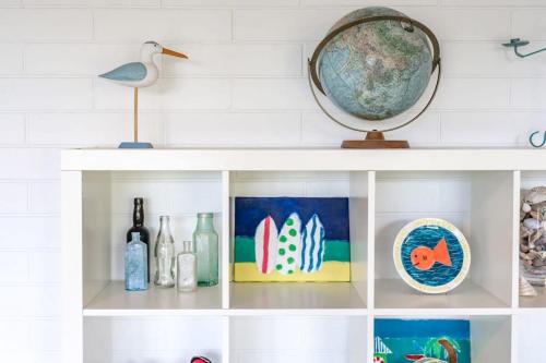 a white shelf with a globe on top of it at 10 Passatt St Encounter Bay - BYO Linen in Encounter Bay