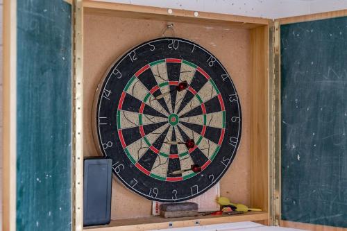 a dart board in a classroom with a chalkboard at 10 Passatt St Encounter Bay - BYO Linen in Encounter Bay