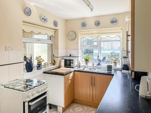a kitchen with a sink and a stove top oven at St Annes Road in Torquay