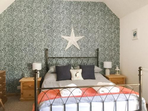 a bedroom with a bed with a star on the wall at The Brae Steading in Fordyce