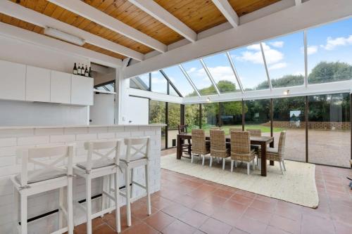 a kitchen and dining room with a table and chairs at The Glass House 103 Bristow-Smith Ave Goolwa South - BYO Linen in Goolwa South