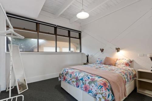 a bedroom with a bed and a large window at The Glass House 103 Bristow-Smith Ave Goolwa South - BYO Linen in Goolwa South