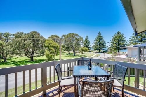 a patio with a table and chairs on a balcony at 4 1 Harbour View Terrace BYO Linen in Victor Harbor