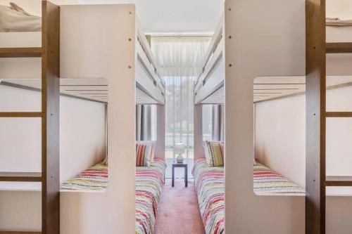 a row of bunk beds in a dorm room at 4 1 Harbour View Terrace BYO Linen in Victor Harbor