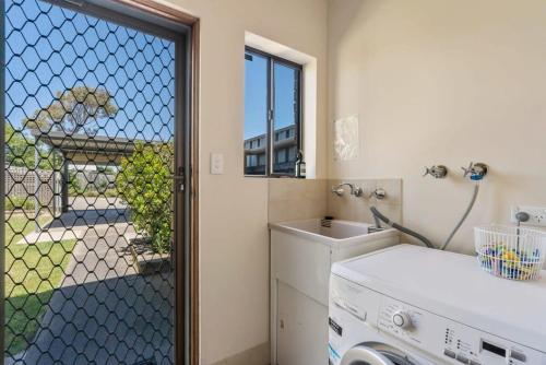 a small kitchen with a sink and a window at 4 1 Harbour View Terrace BYO Linen in Victor Harbor