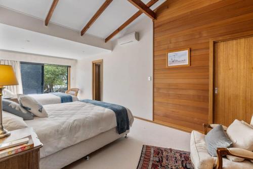 a bedroom with a bed and a wooden wall at 20 Sir George Ritchie Ave Goolwa South - No Linen Included in Goolwa South
