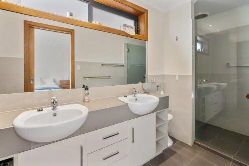 a bathroom with two sinks and a shower at 20 Sir George Ritchie Ave Goolwa South - No Linen Included in Goolwa South