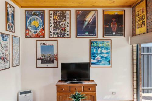 a wall with pictures and a tv on it at 20 Sir George Ritchie Ave Goolwa South - No Linen Included in Goolwa South