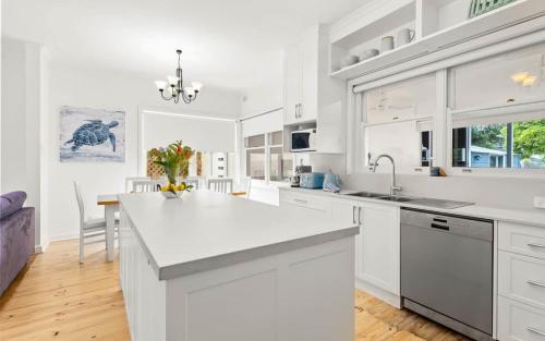 a kitchen with white cabinets and a white counter top at 18 Strangways Tce Port Elliot - Linen Included in Port Elliot