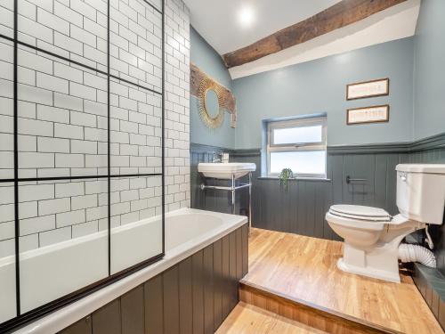 a bathroom with a tub and a toilet and a sink at Ye Ol Tavern in Ruthin