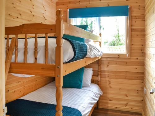 a bunk room with bunk beds in a log cabin at Wellington - Uk47055 in Holme upon Spalding Moor