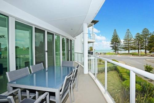 a balcony with a blue table and chairs at Gallery 7 - Town Centre - Wi-Fi - Linen Included in Victor Harbor
